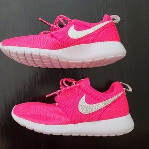 Hot pink bedazzled Nike tennis shoes.